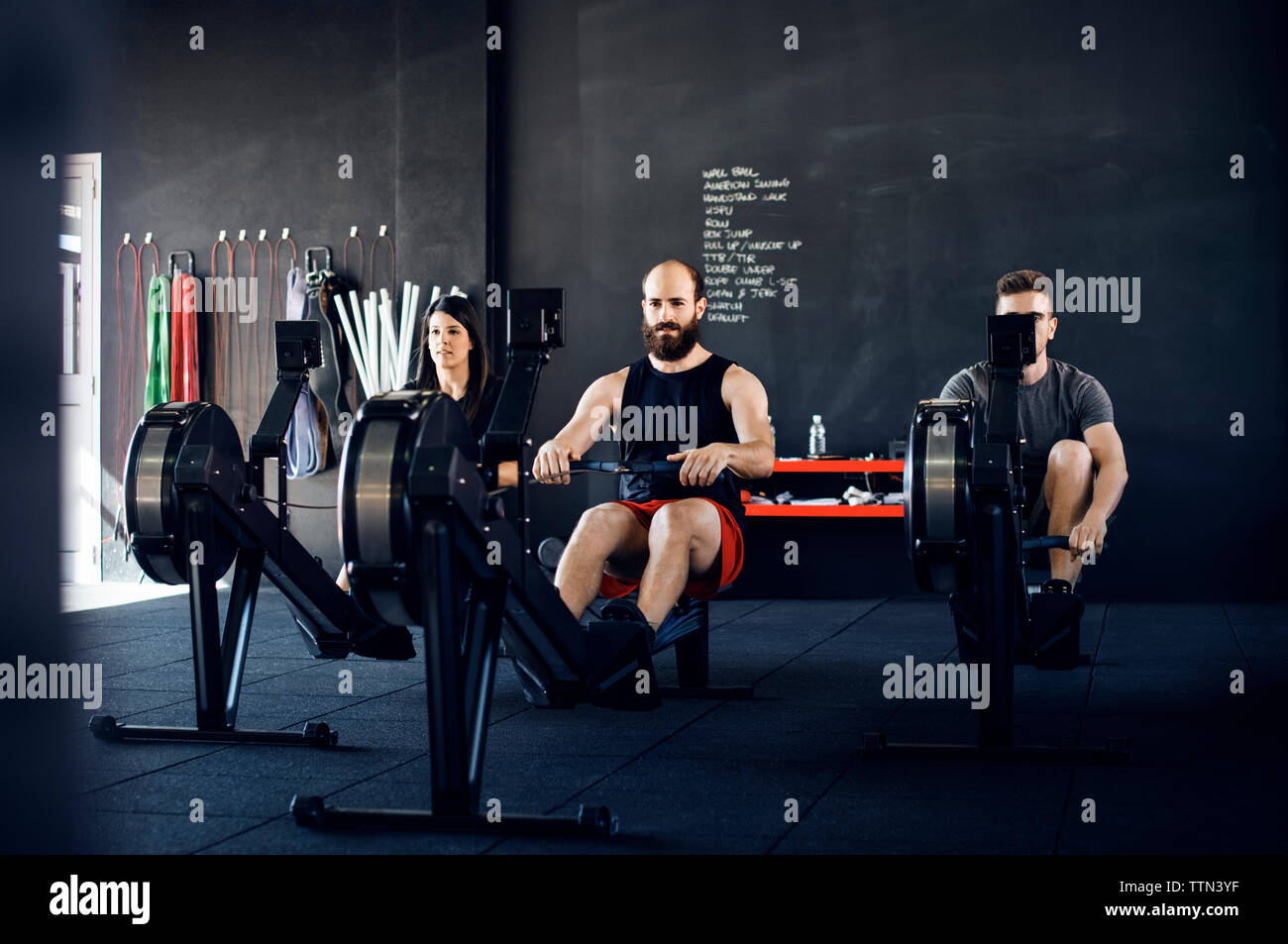 Bestimmt die Athleten trainieren auf rudergerät im Fitnessstudio Stockfoto