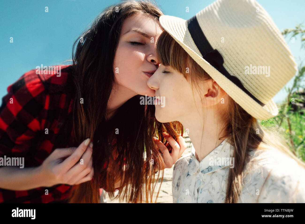Frau küssen Freundin im Freien Stockfoto