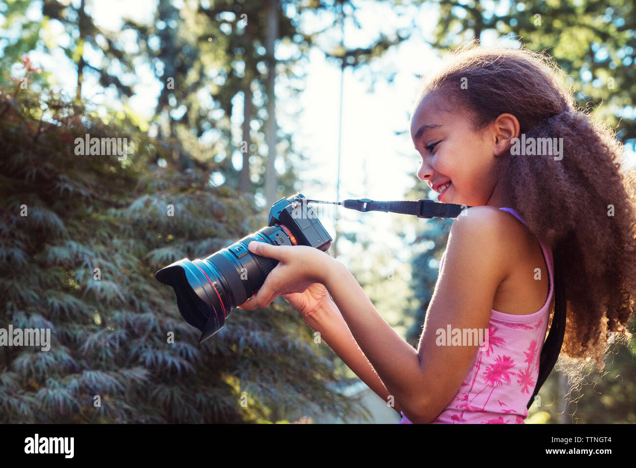 Seitliche Sicht auf Mädchen mit Digitalkamera Stockfoto