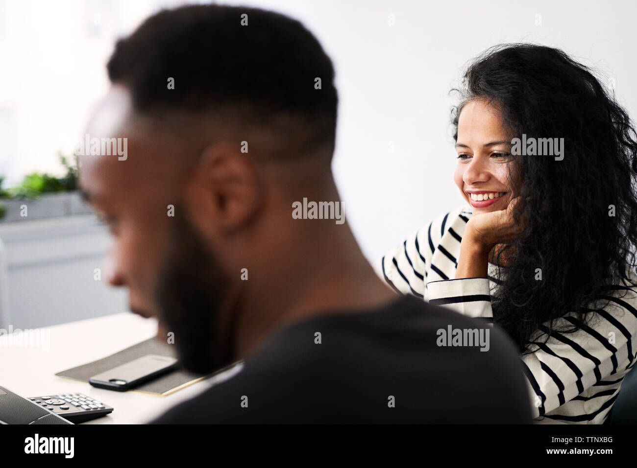 Lächeln, Geschäftsfrau, Arbeiten mit männlichen Kollegen im Büro Stockfoto