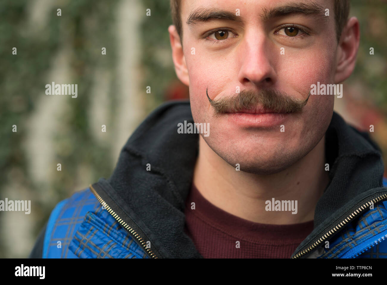 Close-up Portrait von zuversichtlich Mann mit Schnurrbart im Hinterhof Stockfoto