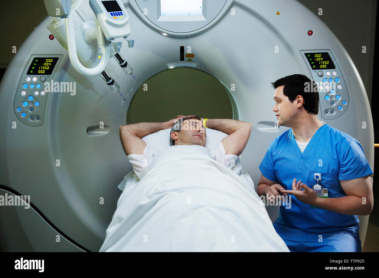 Patient liegt auf CAT Scan Maschine und Reden in dem Krankenhaus, Radiologe Stockfoto