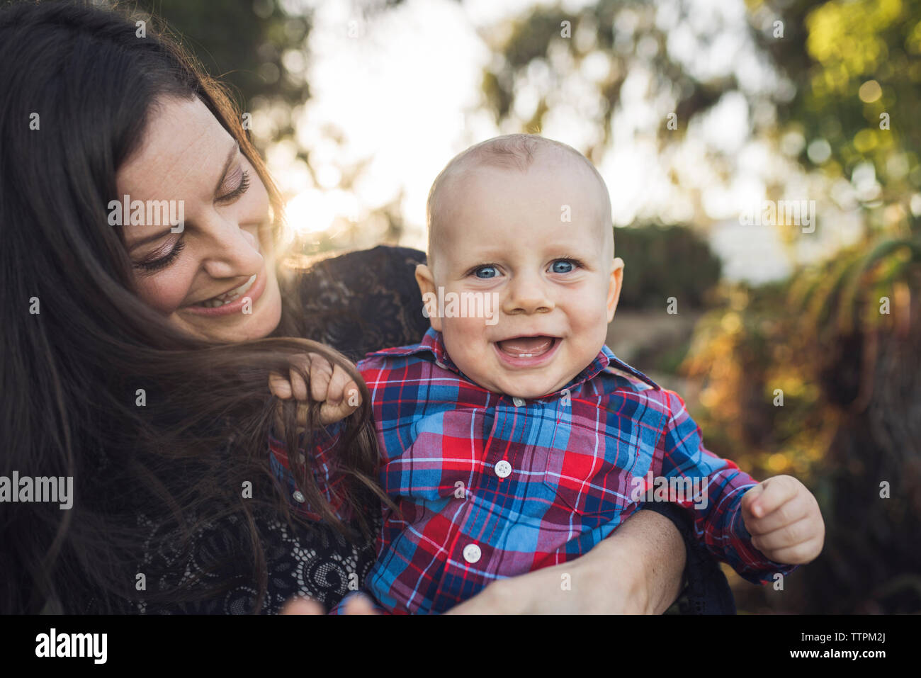 Portrait von fröhlichen Sohn von der Mutter im Park durchgeführt Stockfoto