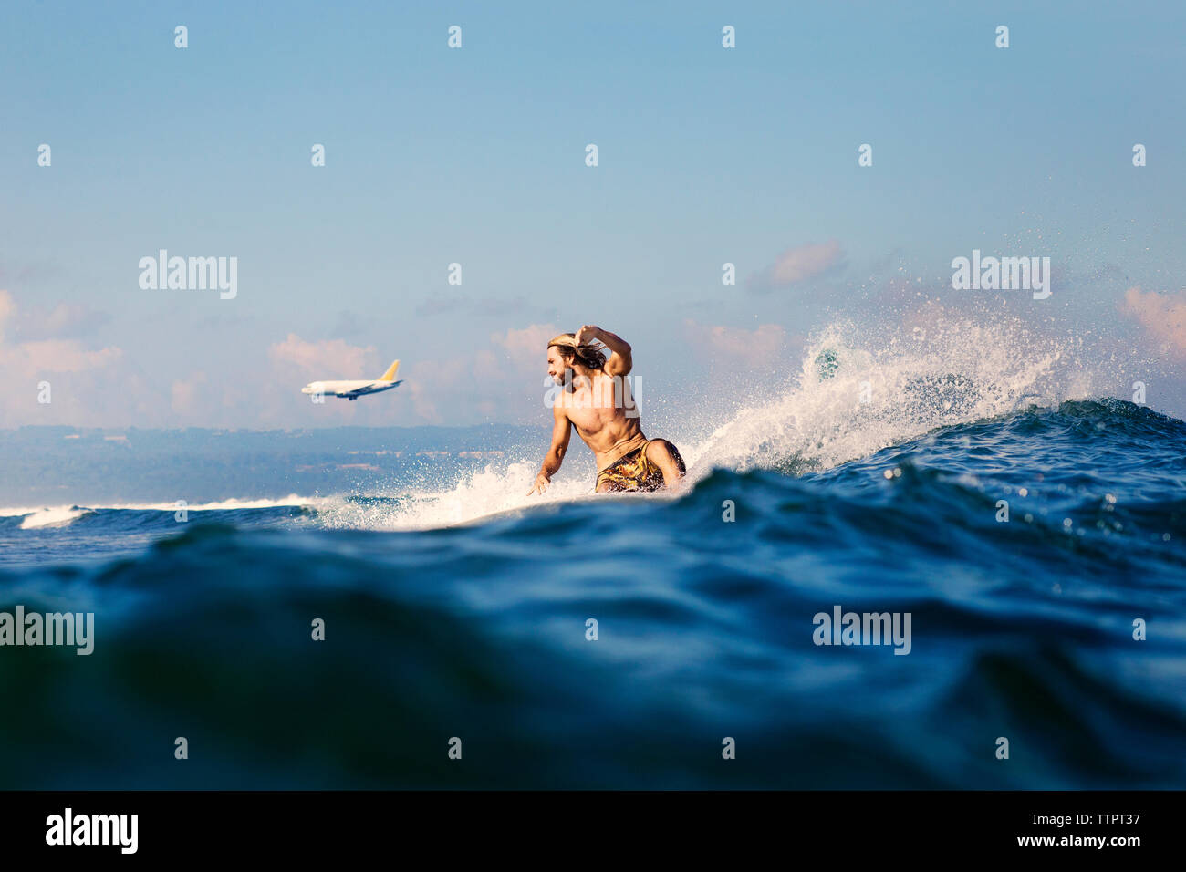 Mitte der erwachsene Mann Surfen im Meer Stockfoto