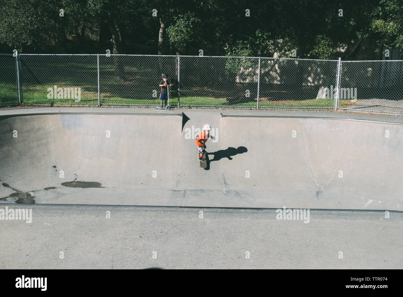 Junge während Bruder skateboarding auf Sport Rampe im Park Stockfoto