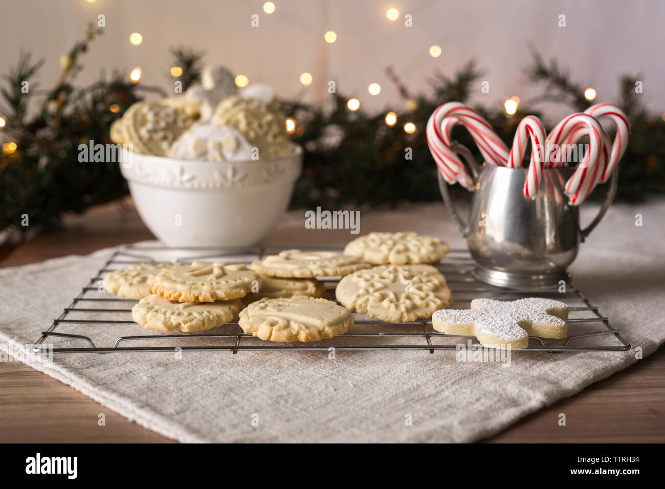 Nahaufnahme von Desserts mit weihnachtsdekoration auf Kühlregal gegen beleuchtete Lichter Stockfoto