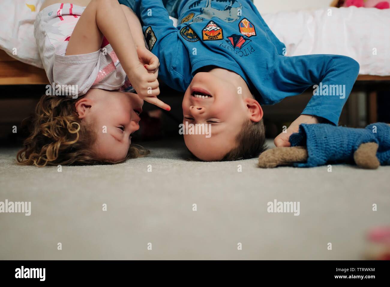 Bruder und Schwester Lachen spielen im Schlafzimmer. Geschwister Spaß Stockfoto