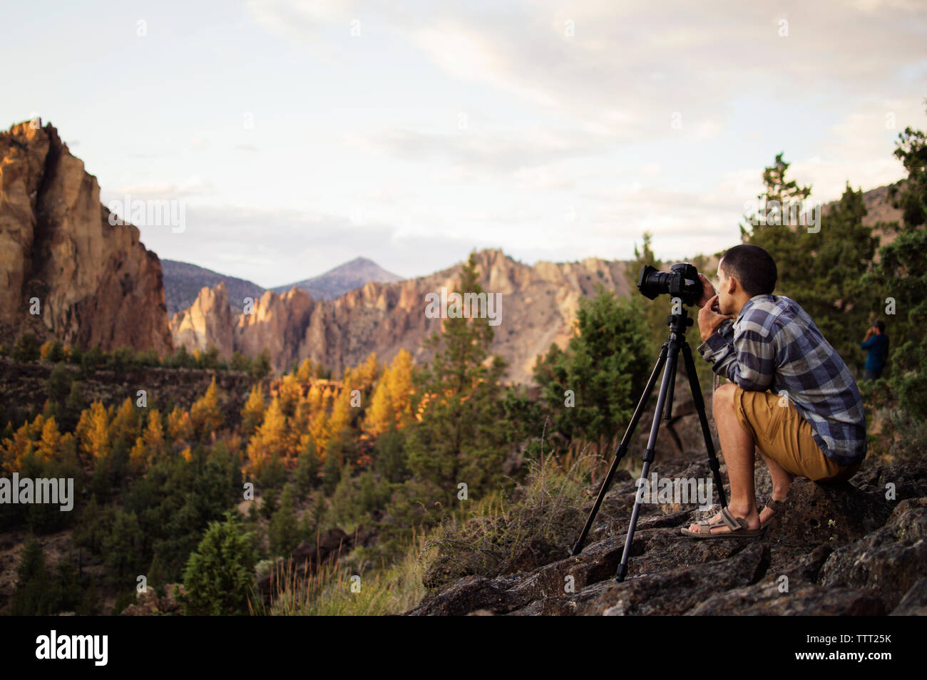Seitenansicht der Wanderer das Fotografieren während der Sitzung auf dem Berg im Herbst Stockfoto