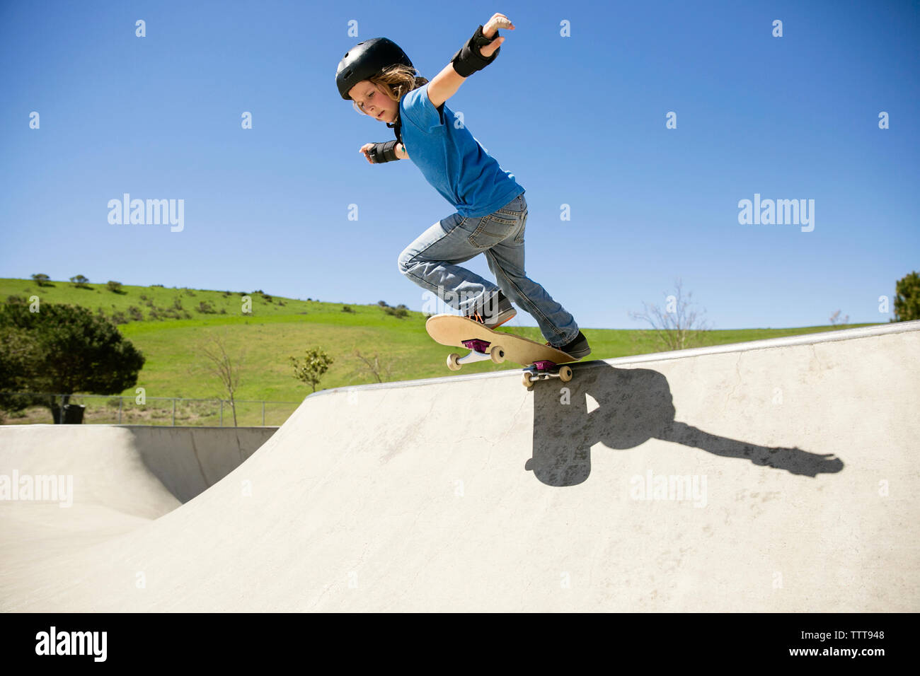 Low Angle View der Boy skateboarding auf Rampe gegen den klaren blauen Himmel Stockfoto