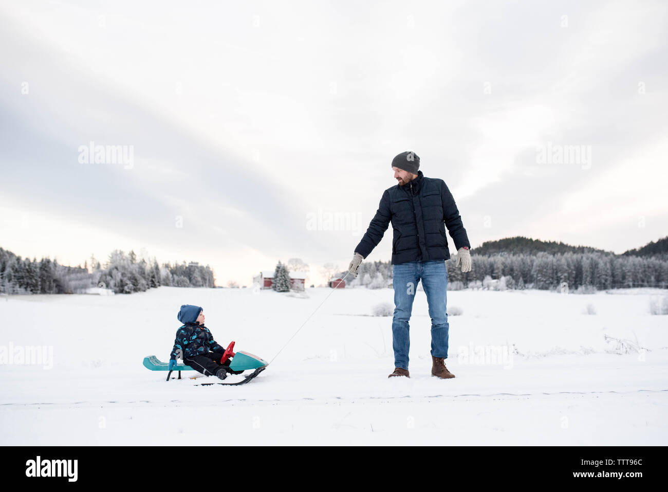 Vater Sohn wandern Rodeln im Schnee weißen wald winter wonderland Stockfoto