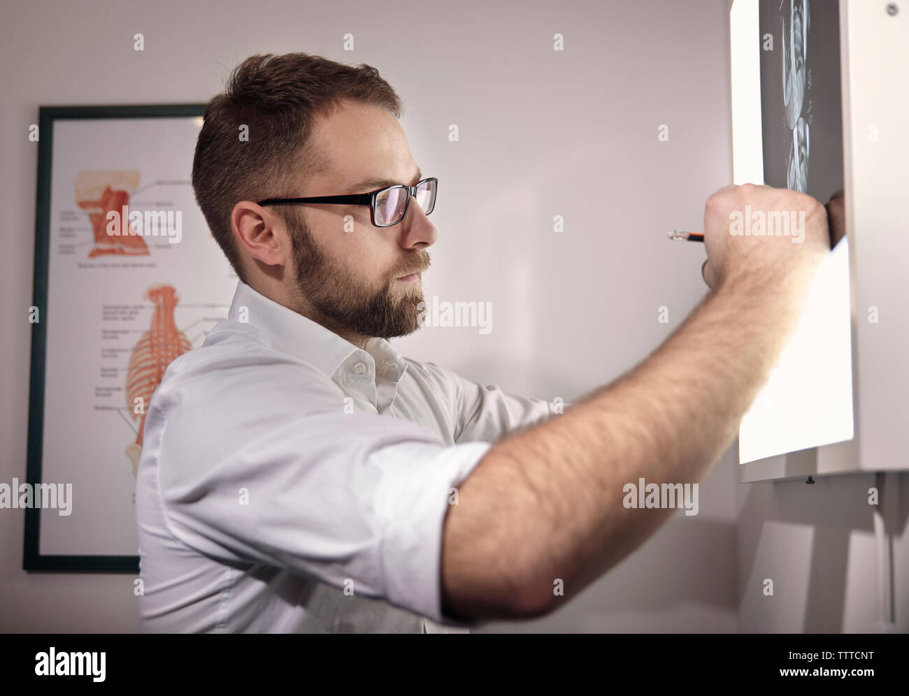 Seitenansicht der männlichen Arzt Prüfung medical x-ray am Krankenhaus Stockfoto