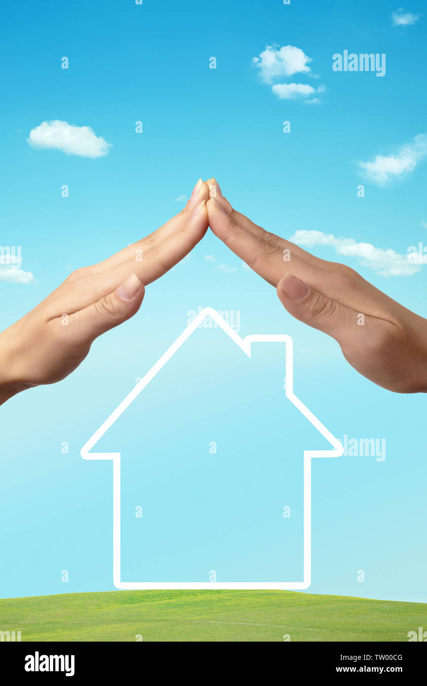 Menschliche Hände schützen ein Haus Stockfoto