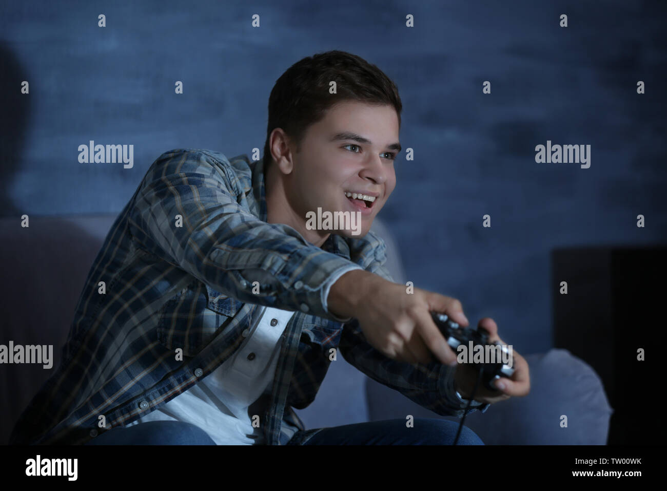 Teenager spielen Videospiel zu Hause am späten Abend Stockfoto