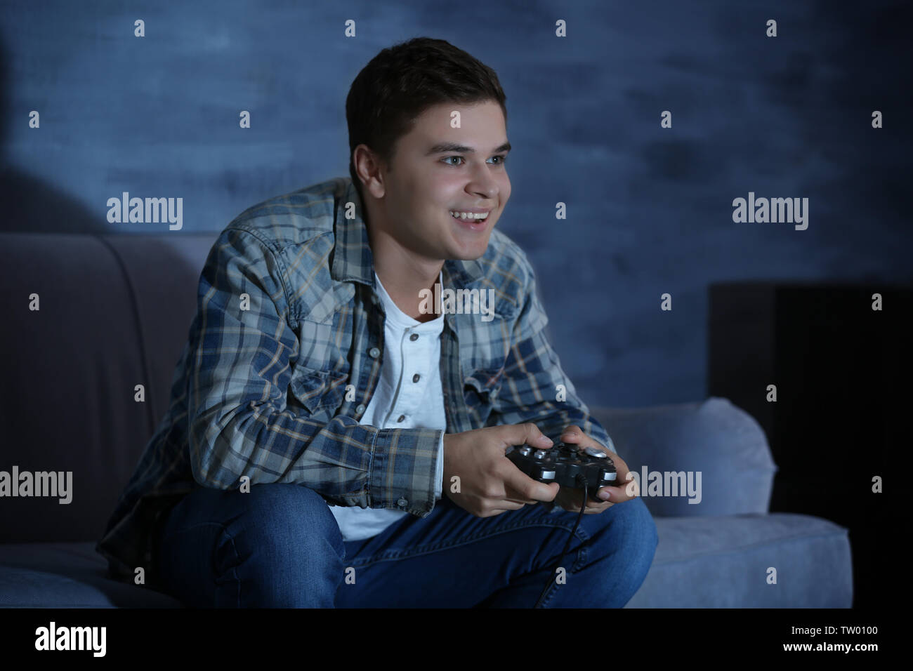 Teenager spielen Videospiel zu Hause am späten Abend Stockfoto