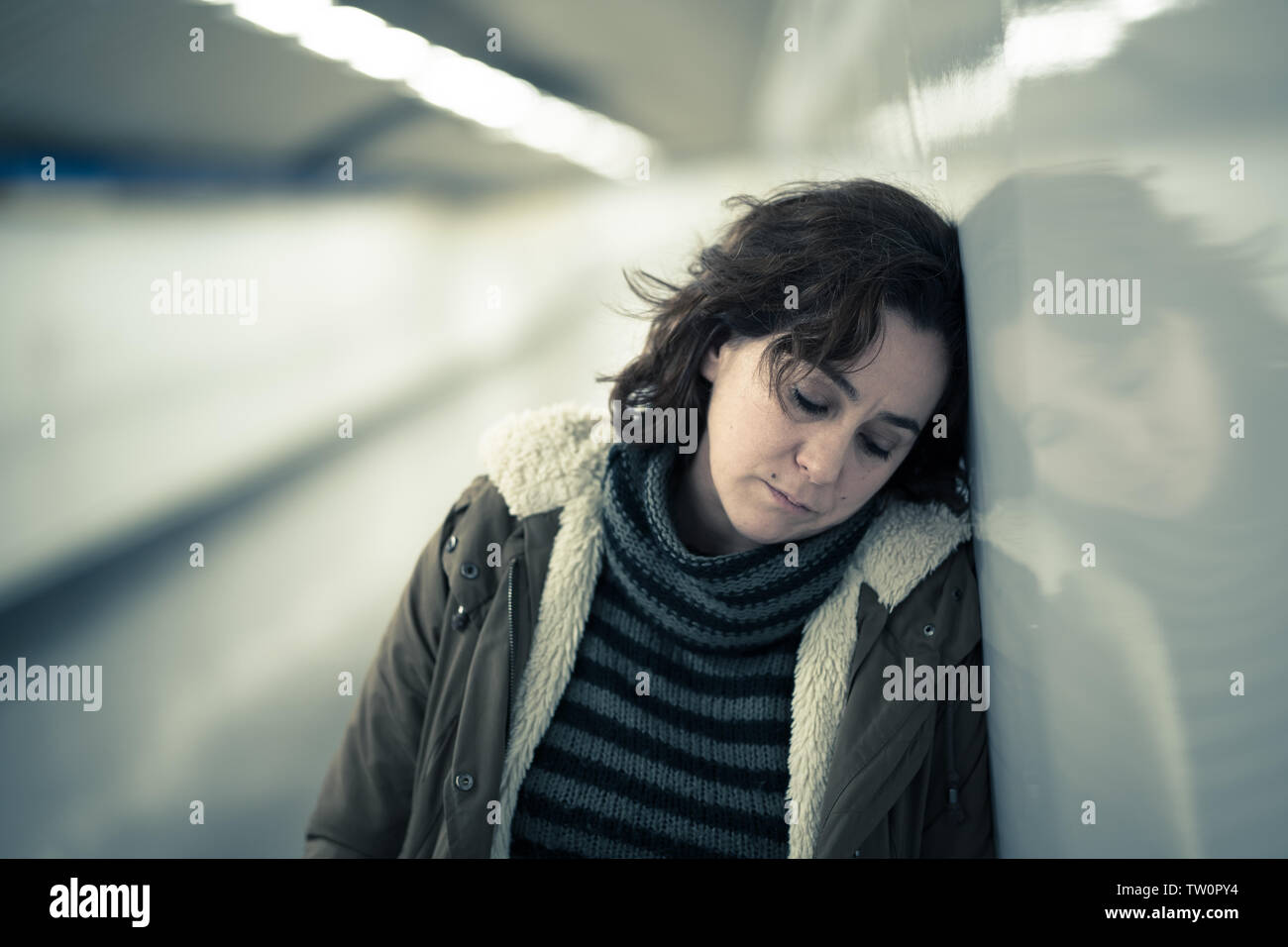 Hoffnungslos und erschöpfte Frau mit Depressionen und Angstzuständen in der Nähe der U-Bahn Tunnel in die Work-Life-Balance Probleme negatives Körperbild finanzielle Schwierigkeiten und Stockfoto