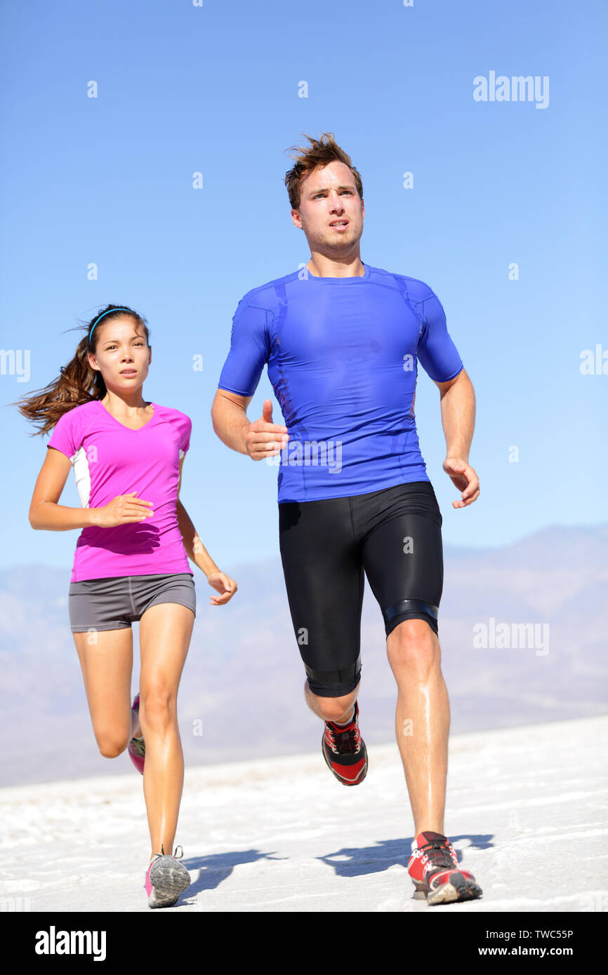 Marathon Athleten paar Ausbildung in der Wüste. Fitness Sport Läufer Leben aktiven Lebensstil. Fit sport Paar, asiatische Frau, kaukasische Mann. Stockfoto