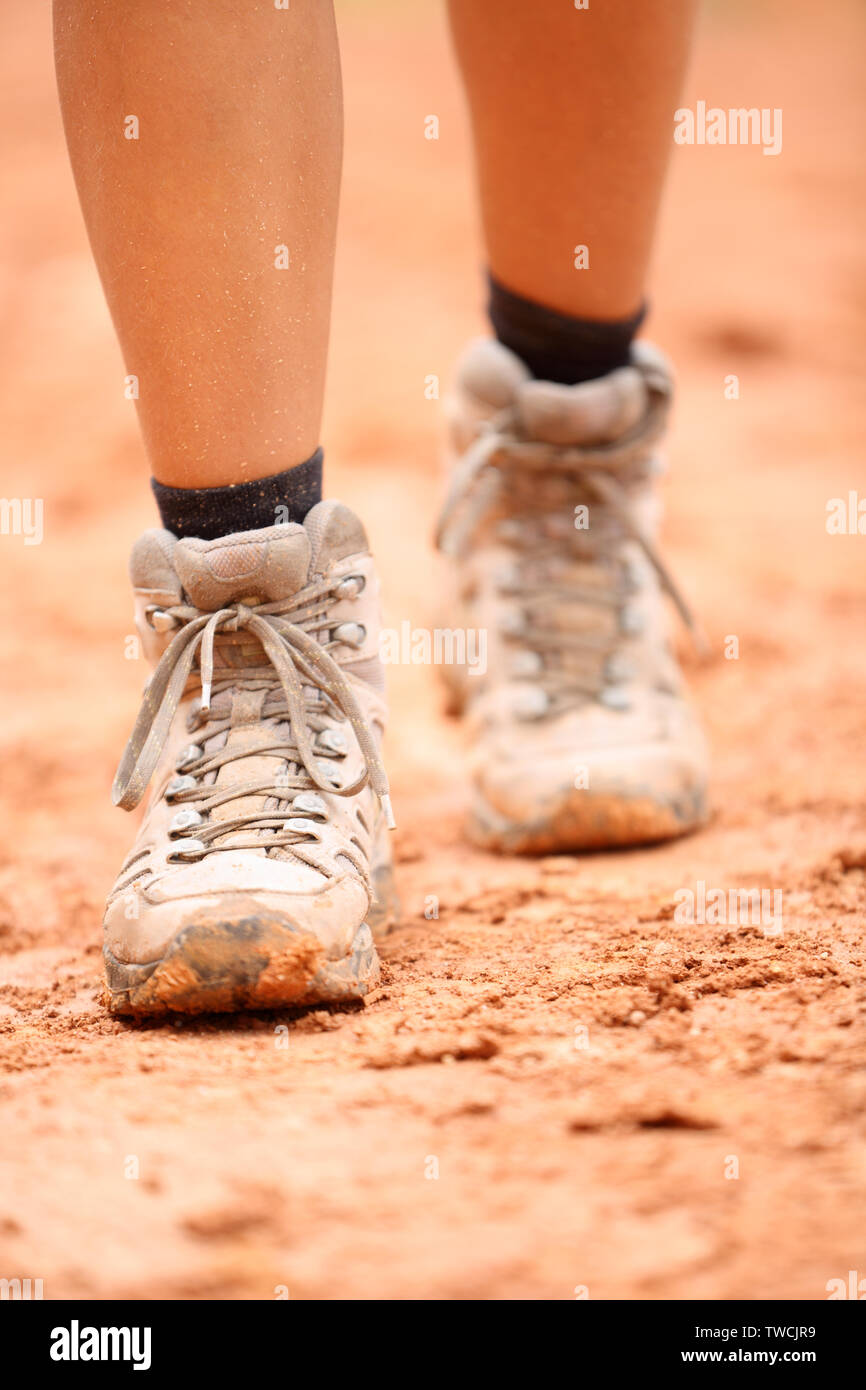 Wanderschuhe - Nahaufnahme der schmutzigen Wanderer Schuhe. Frau Füße und weibliche Wanderer schuhe Schuh walking auf Schmutz Trail Wanderung Pfad outdoor in der Natur. Stockfoto
