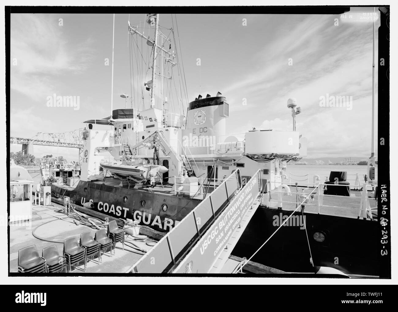 Backbordseite des Schiffes. CREWMAN SCHMIEREN KRAN. - Der U.S. Coast Guard Cutter BUTTONWOOD, Yerba Buena Island, San Francisco, San Francisco County, CA Stockfoto