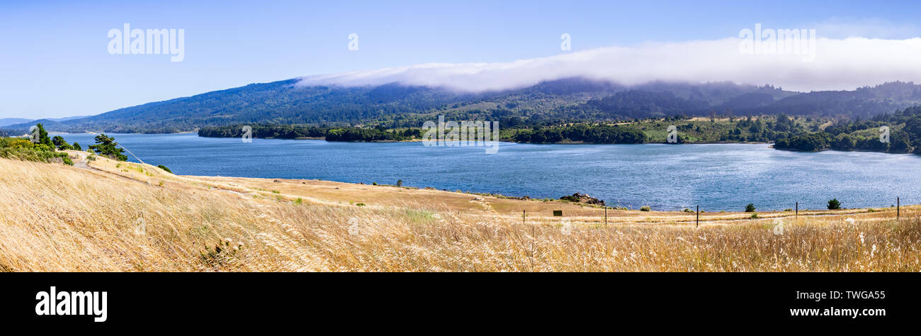 Obere Crystal Springs Reservoir, Teil der San Mateo Nebenfluss-wasserscheide und Santa Cruz Berge bedeckt mit Wolken im Hintergrund sichtbar; San Ma Stockfoto