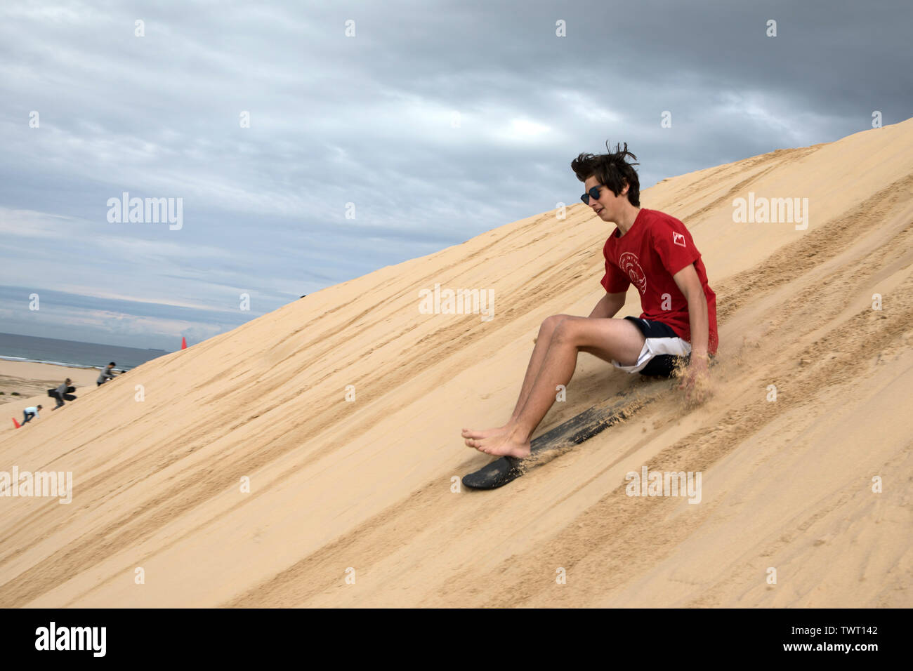 Sand Surfen, Stockton Strand, NSW, Australien Stockfoto