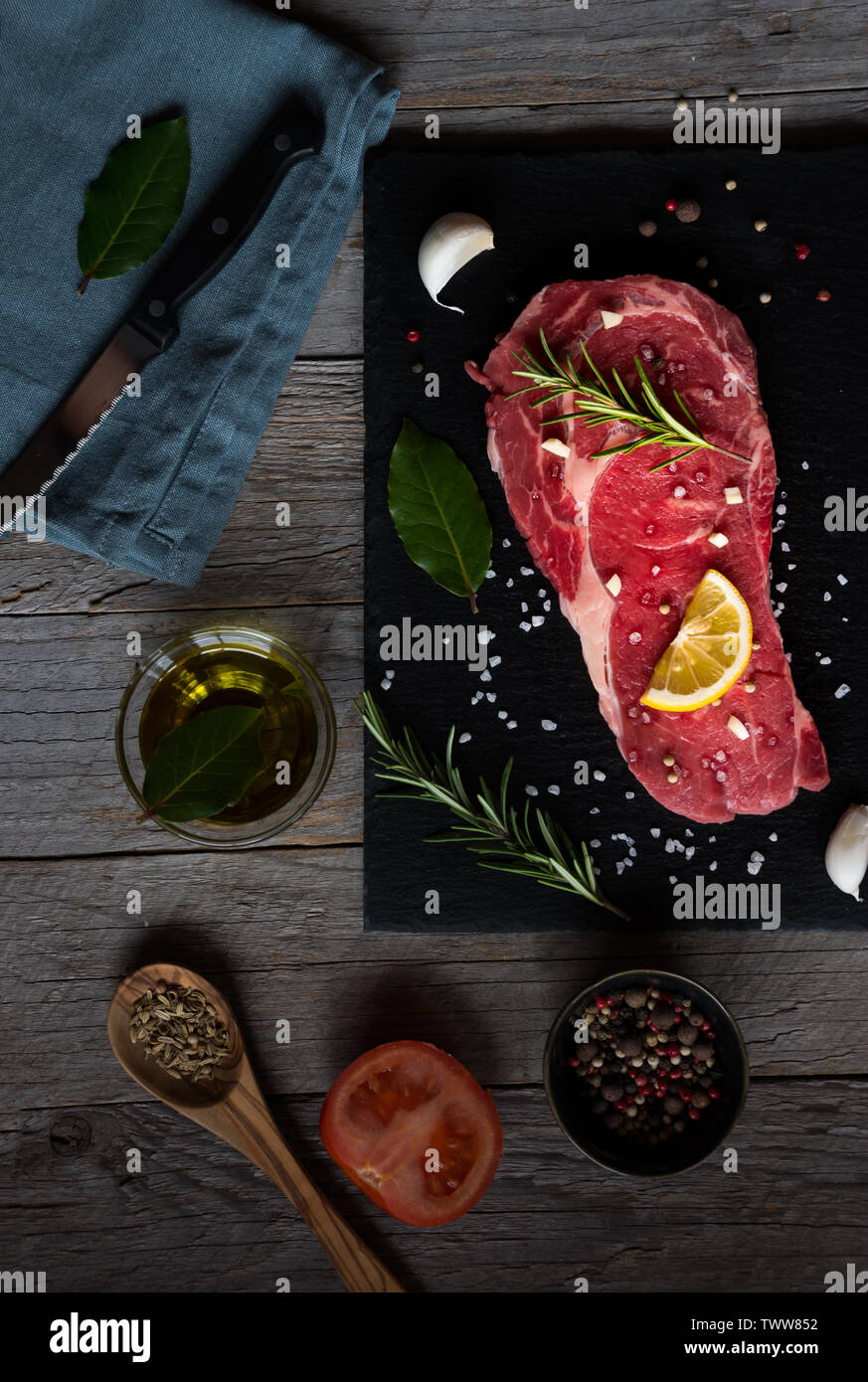 Raw reef Fleisch, rohe Steak mit Rosmarin, Zitrone und Gewürze, bereit zu kochen Stockfoto