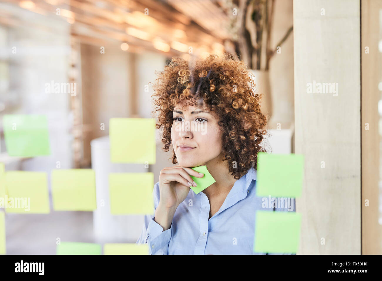 Geschäftsfrau Brainstorming mit Post-its auf der Glasscheibe Stockfoto