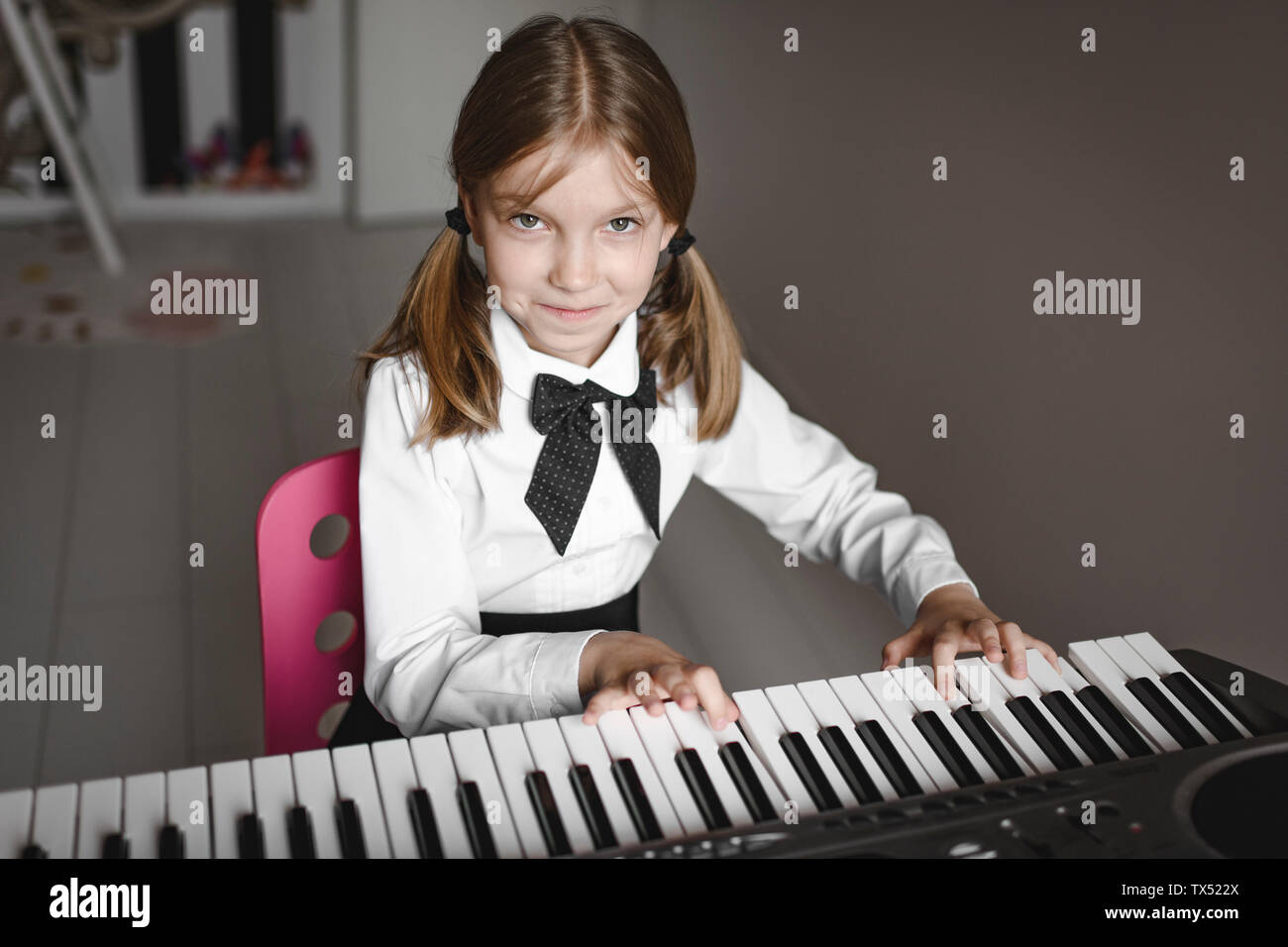 Porträt eines lächelnden Mädchen spielen Synthesizer Stockfoto