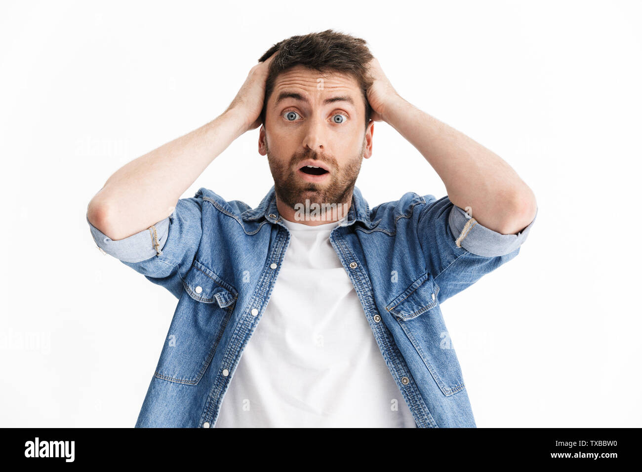 Porträt einer entsetzt, verwirrt aussehenden bärtigen Mann legere Kleidung, die auf weißem Hintergrund Stockfoto
