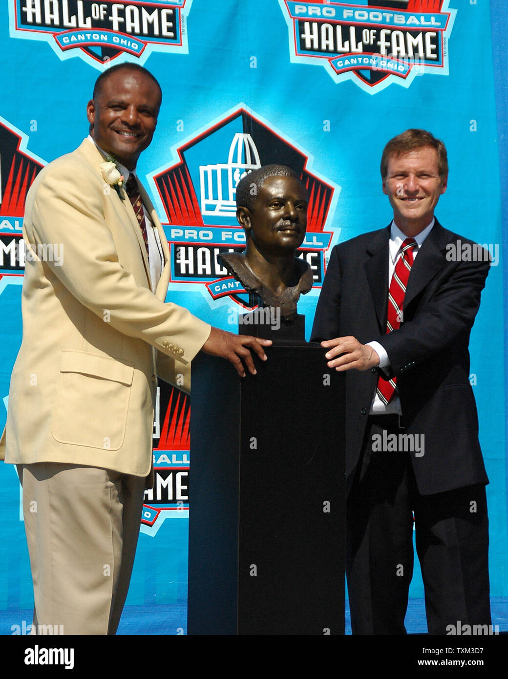 Warren Moon und seine Presenter Leigh Steinberg, seinen Sport Agent und langjähriger Freund, posieren für die Medien mit dem Mond Bronzebüste nach dem Football Hall of Fame Verankerung Zeremonie am 5. August 2006 in Canton, Ohio. (UPI Foto/Stephanie Krell) Stockfoto