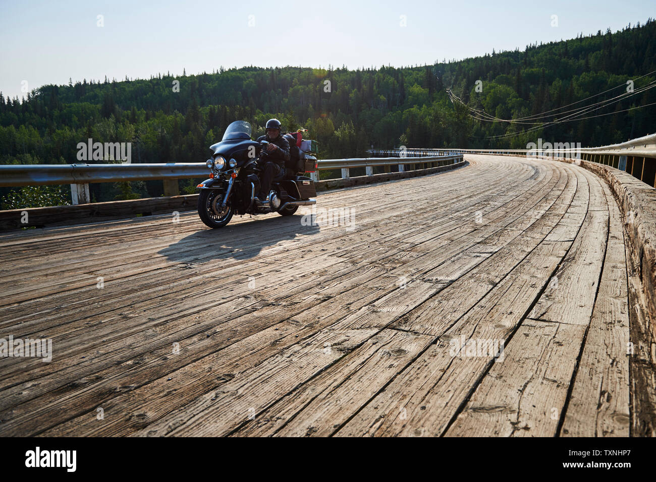 Ältere männliche Motorradfahrer Kreuzung Kiskatinaw Brücke, Dawson Creek, Kanada Stockfoto