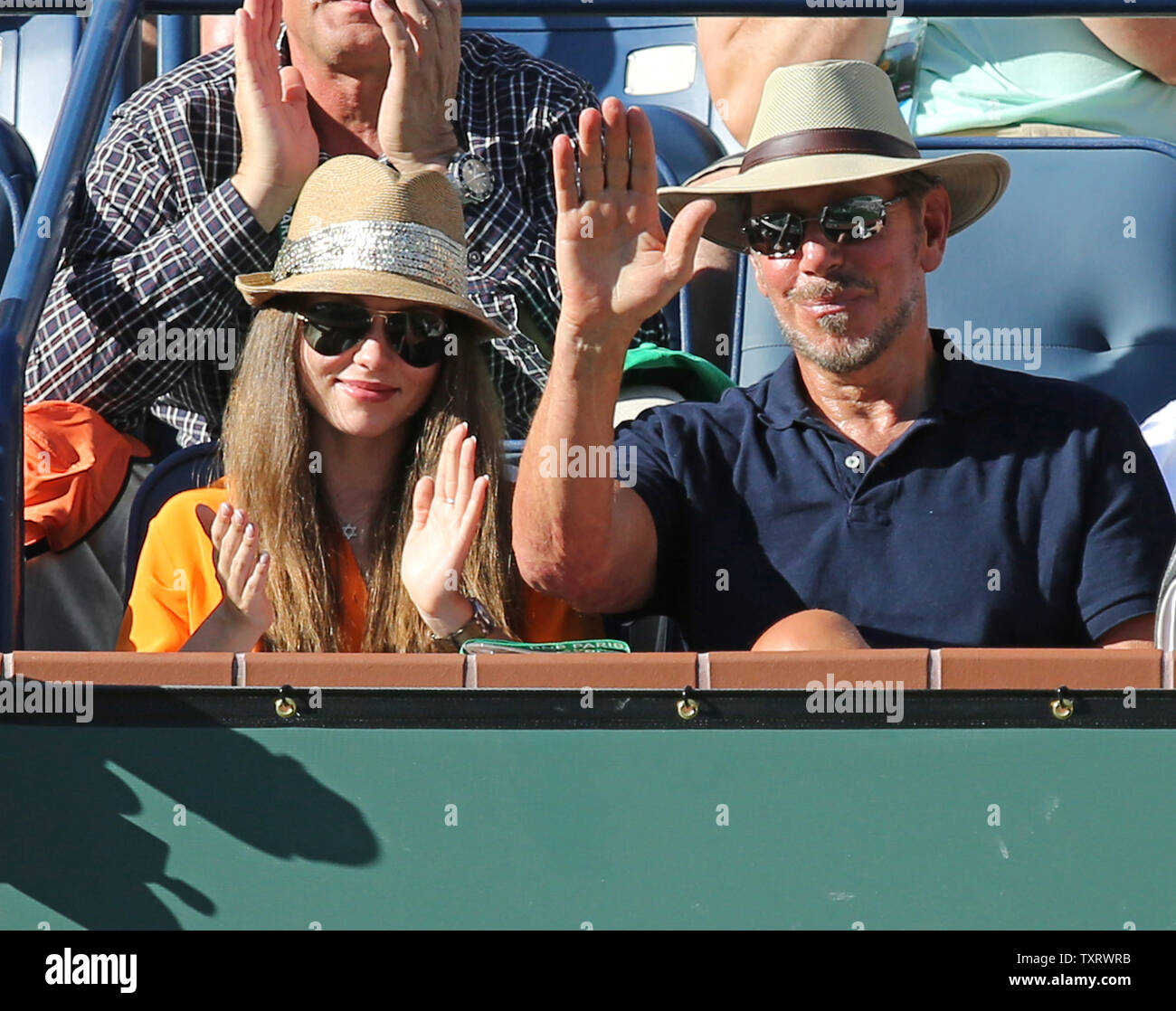 Oracle CEO und Turnier Mehrheit Besitzer Larry Ellison (R) und seine Freundin Nikita Kahn erkennen die Spieler nach dem Finale der Männer Match zwischen Roger Federer und Novak Djokovic aus Serbien an der BNP Paribas Open in Indian Wells, Kalifornien am 16. März 2014. Djokovic besiegt Federer 3-6, 6-3, 7-6 (3) das Turnier zum dritten Mal zu gewinnen. UPI/David Silpa Stockfoto