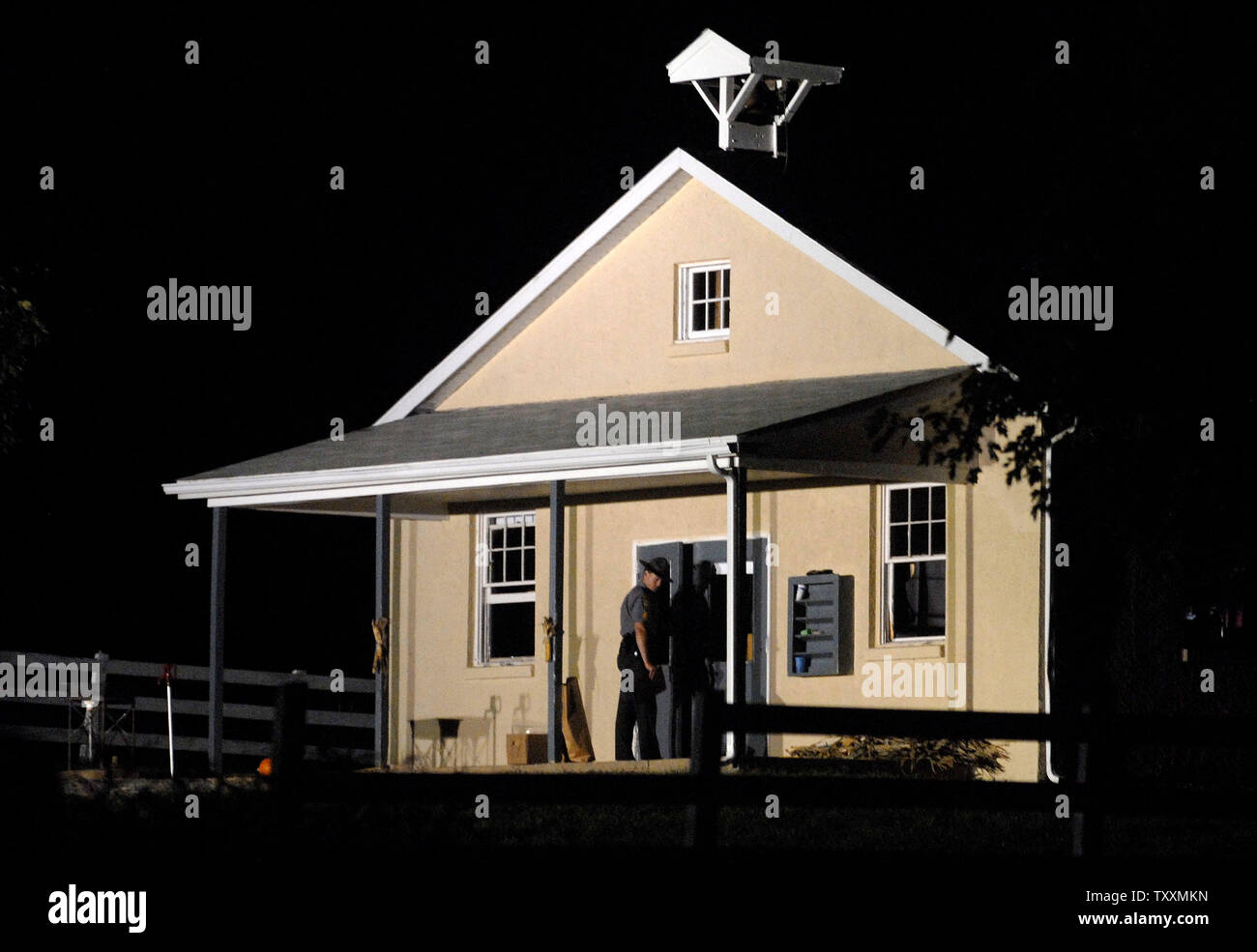Ein Pennsylvania State Trooper schließt die Türen zu den Nickel Mines Schule Haus, als die Polizei weiter Beweise Stunden zu sammeln, nachdem ein Amoklaeufer die Schule gestürmt, selbst im Inneren verbarrikadiert und tötete mehrere Mädchen "execution Style", bevor sie die Waffe auf sich selbst, in Nickel Mines, Pennsylvania am 2. Oktober 2006. (UPI Foto/Kevin Dietsch) Stockfoto