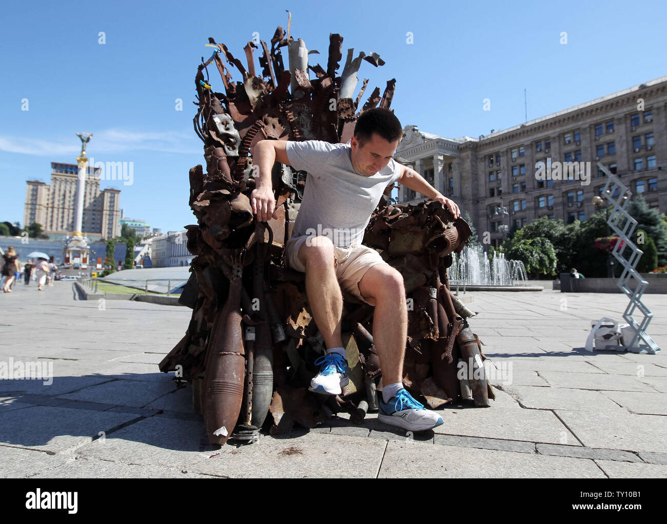 Juni 25, 2019 - Kiew, Ukraine - ein Mann sitzt auf dem "Der Eiserne Thron des Ostens' Kunst arbeiten, die auf dem Platz der Unabhängigkeit in Kiew, Ukraine, am 25. Juni 2019 vorgestellt. "Der Eiserne Thron des Ostens' war ein Ukrainischer freiwilliger Kämpfer Denis Bushtets im Krieg Konfliktgebiet in der östlichen Ukraine in der Nähe von Donezk im Jahr 2016 erstellt. Das kunstobjekt ist aus den Trümmern der Tank Rüstung vorgenommen, Teile der zerstörten militärischen Ausrüstungen, Maschinengewehre, Granaten, Kanistern und Soldatischen Kolben und es ist Gewicht über 600 Kg. Ein Prototyp eines berühmten Bügeleisen Thron von Spiel der Throne TV-Serie ist eine Erinnerung an eine blutige conf Stockfoto