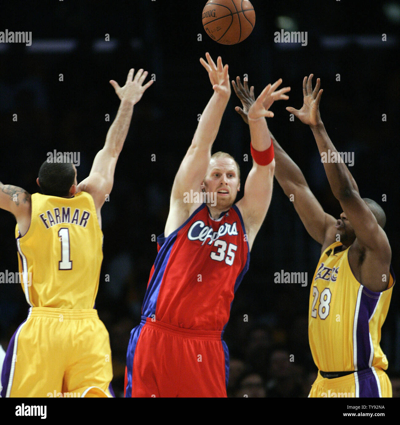 Los Angeles Clippers center Chris Kaman, Center, passt den Ball weg, als Los Angeles Lakers guard Jordan Farmar, Links, Andrés D.J. Mbenga, rechts, verteidigen in der ersten Hälfte der NBA Basketball Spiel in Los Angeles am 27. Oktober 2009. UPI/Lori Shepler Stockfoto