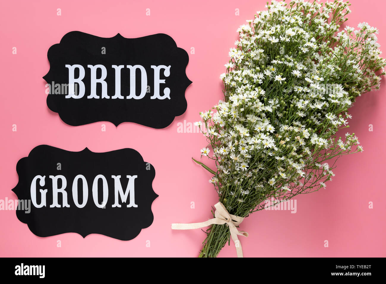 Braut und Bräutigam text Zeichen auf rosa Hintergrund mit weißen Blumen Bouquet eingerichtet, Vintage Style. Hochzeit schild Konzept Stockfoto