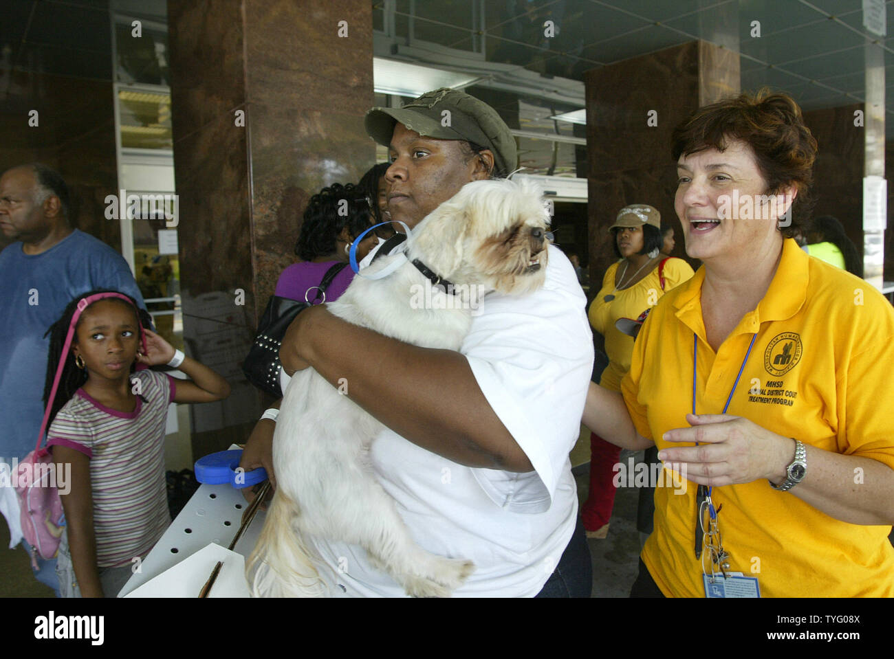 Sylvania Moore trägt Buddy der Hund, wie sie sich vorbereiten, nach Shreveport, La, aus New Orleans Samstag, 30. August 2008 zu evakuieren. Staatliche Mitarbeiter Rena Smith, rechts, führt Moore zusammen. (UPI Foto/A.J. Sisco) Stockfoto