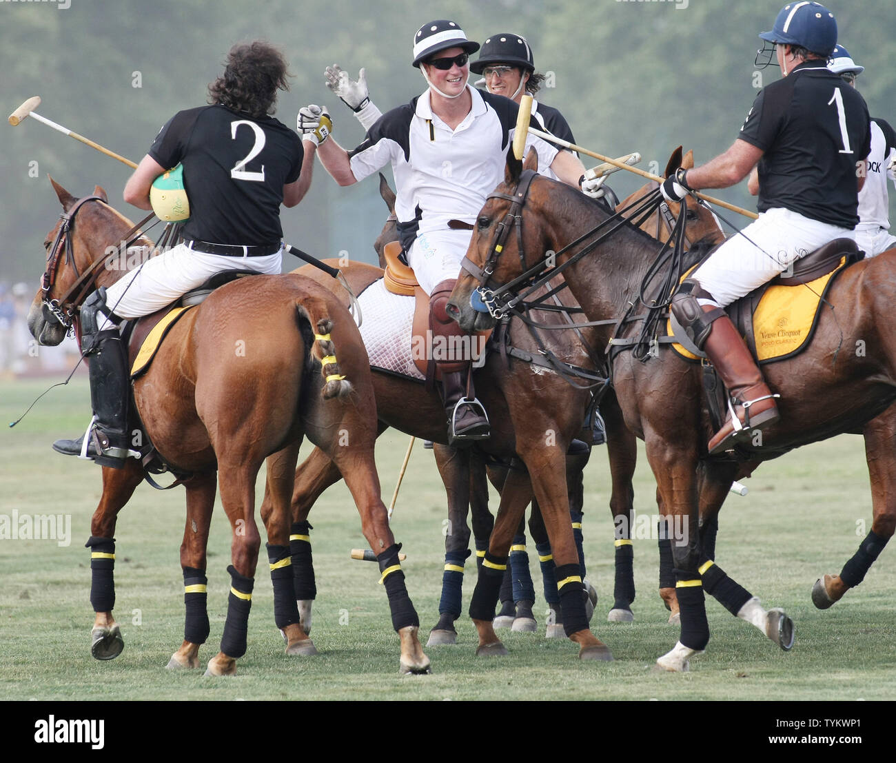 Prinz Harry von Wales (2. L) gratuliert durch Mitspieler am Ende ihrer Polo Match während des dritten jährlichen Veuve Clicquot Polo Classic Match auf Governors Island am 27. Juni 2010 in New York. UPI/Monika Graff Stockfoto