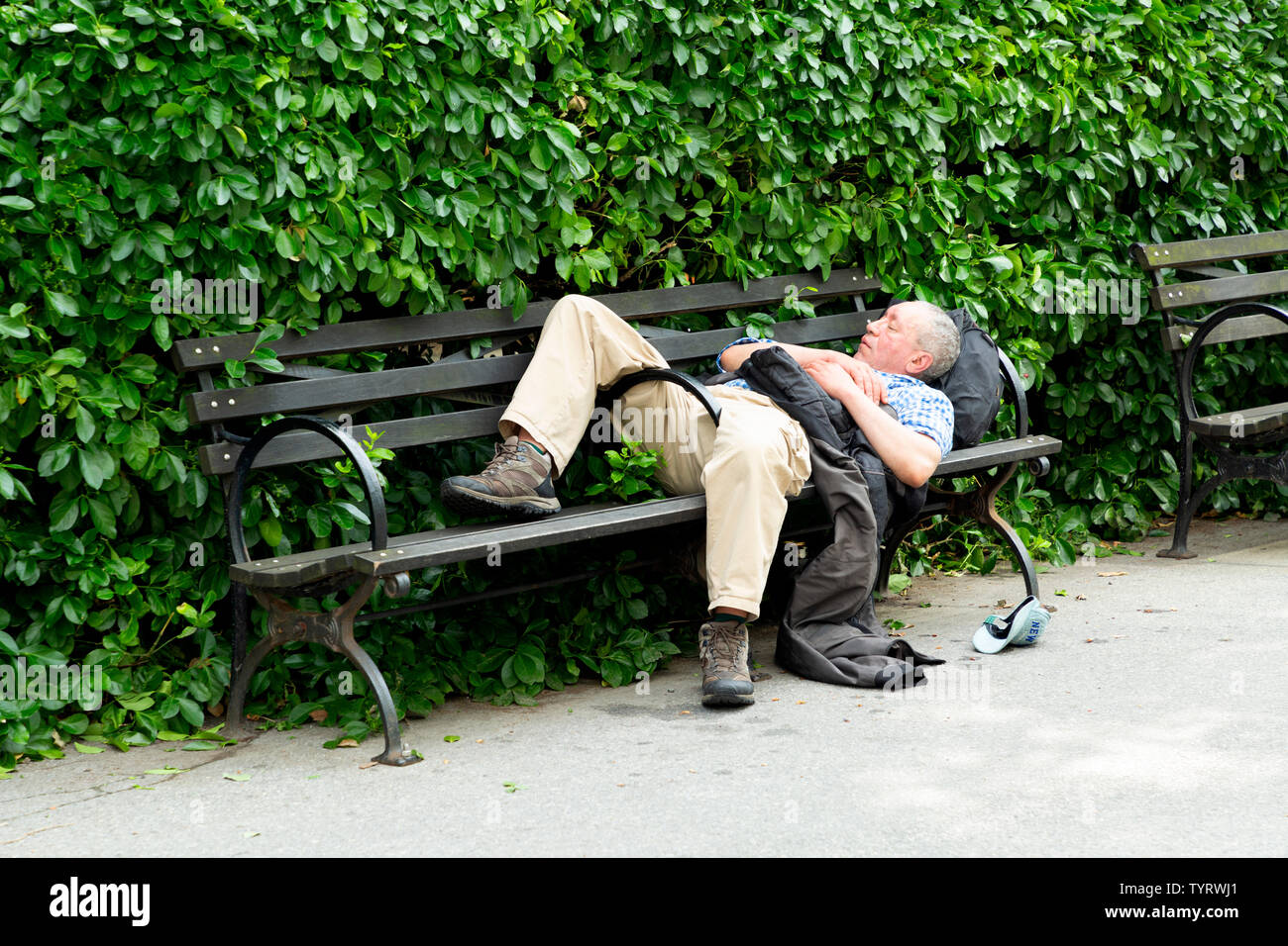 Menschen schlafen auf einer Parkbank im Battery Park in New York City NY USA Stockfoto