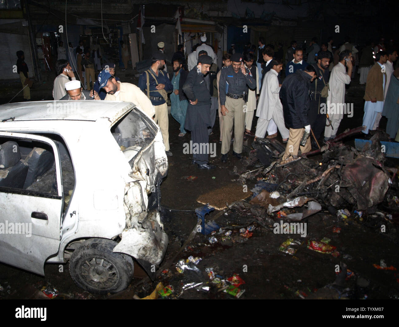 Die pakistanischen Polizisten inspizieren ein Fahrzeug von einem Auto Bombenanschlag in Charsadda, Pakistan am 10. November 2009 zerstört. Die Autobombe explodierte vor einem überfüllten Markt im Nordwesten Pakistans tötet 24 Menschen in dem jüngsten Angriff. UPI/Sajjad Ali Qureshi. Stockfoto