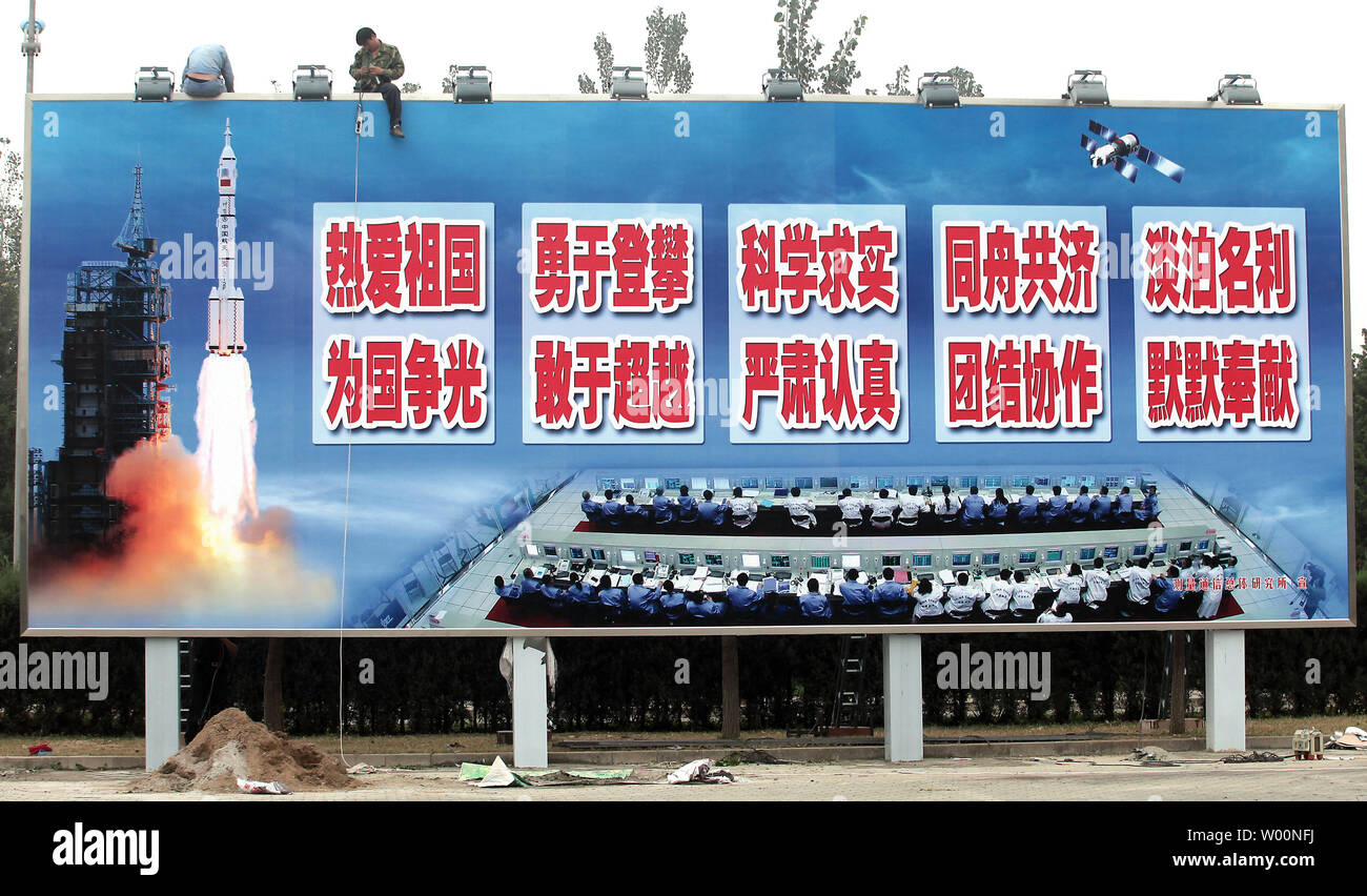 Ein chinesischer Arbeiter installiert leuchtet auf einem riesigen Reklametafeln feiert China's space Program in der Nähe von Pekings Tempo Stadt" am 6. Oktober 2009. China ist aggressiv Beschleunigung der bemannten Raumfahrt durch die Entwicklung einer 17.000 lb. bemannten Militärische Raumfahrt Labor, die bis Ende 2010 geplant. Die Mission wird mit einem Halt in den USA übereinstimmen, die bemannte Raumfahrt mit der Phase-out des Shuttles. UPI/Stephen Rasierer Stockfoto