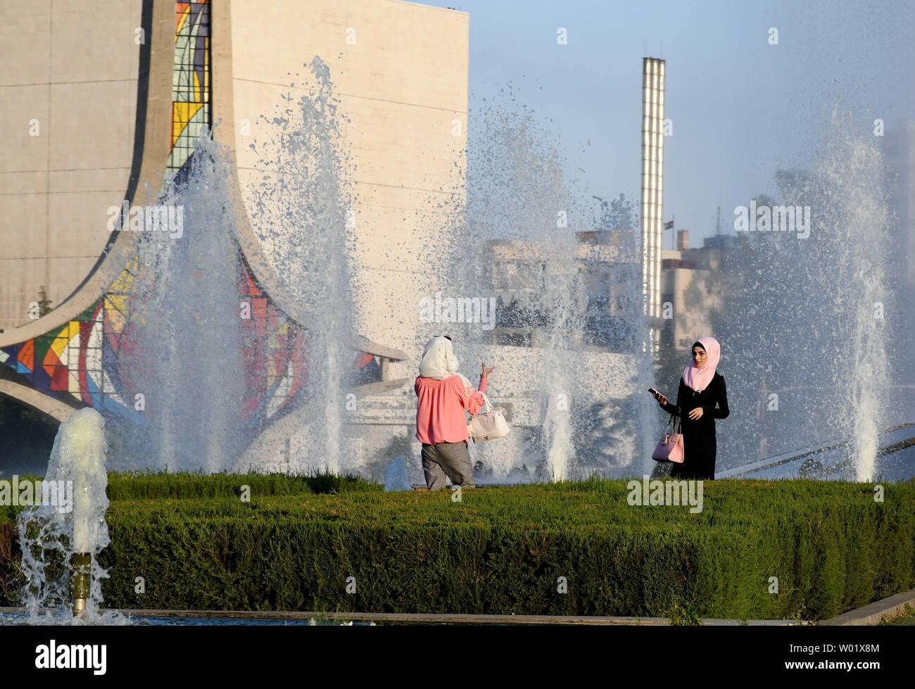 Damaskus, Syrien. 26 Juni, 2019. Syrer genießen Sie Ihre Zeit in der Nähe von Brunnen in der Umayyaden Square in Damaskus, Syrien, am 26. Juni 2019. Menschen in Damaskus leiden Wärme, die Temperatur war höher als normal. Credit: Ammar Safarjalani/Xinhua/Alamy leben Nachrichten Stockfoto