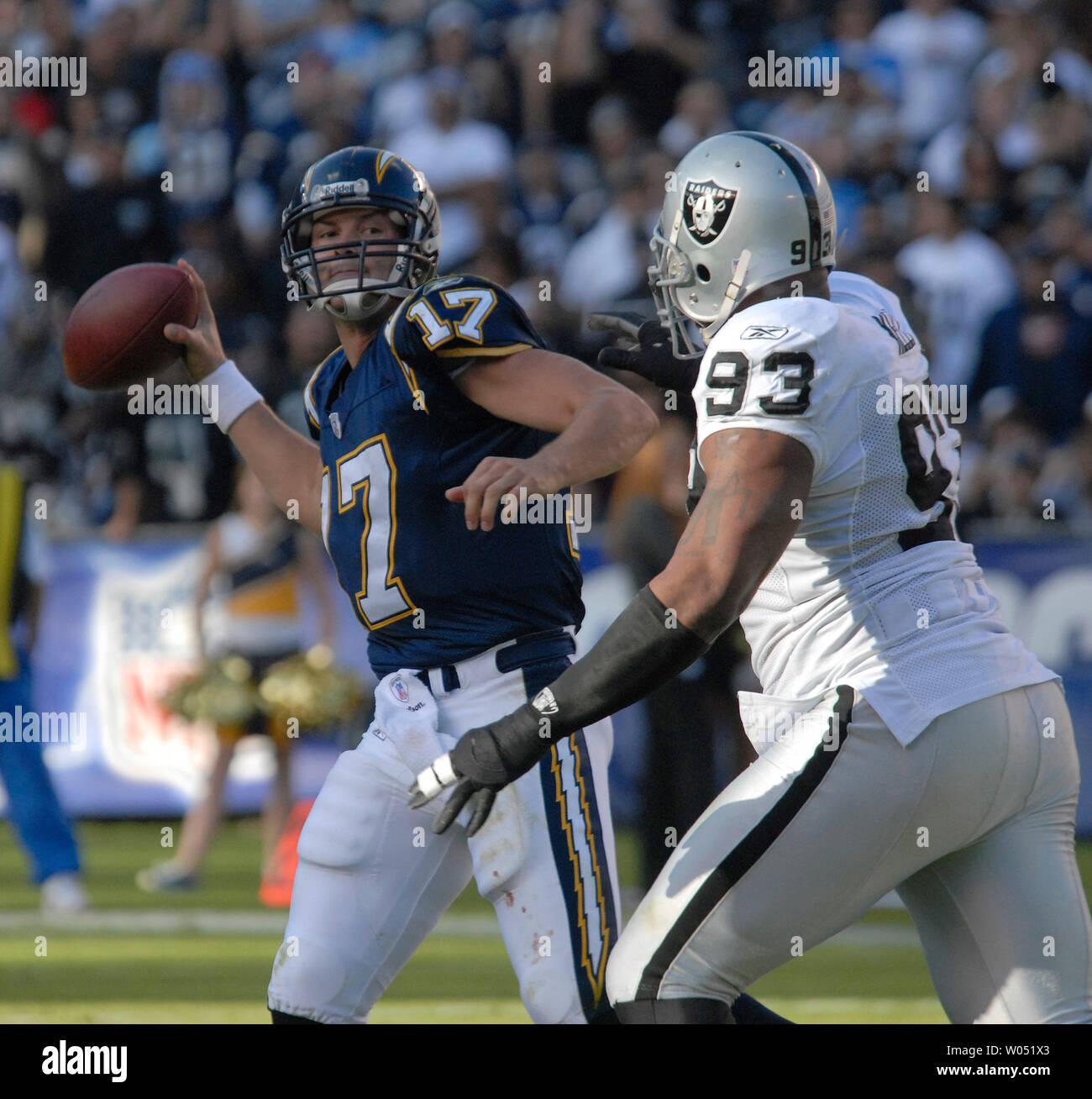 San Diego Aufladeeinheiten Quarterback Phillip Flüsse (17) wirft unter dem Druck von Oakland Raiders defensiver Tommy Kelly (93) während der ersten Hälfte bei Qualcomm Stadion in San Diego am 26. November 2006. Die Ladegeräte besiegt die Räuber 21-14. (UPI Foto/Earl S. Cryer) Stockfoto