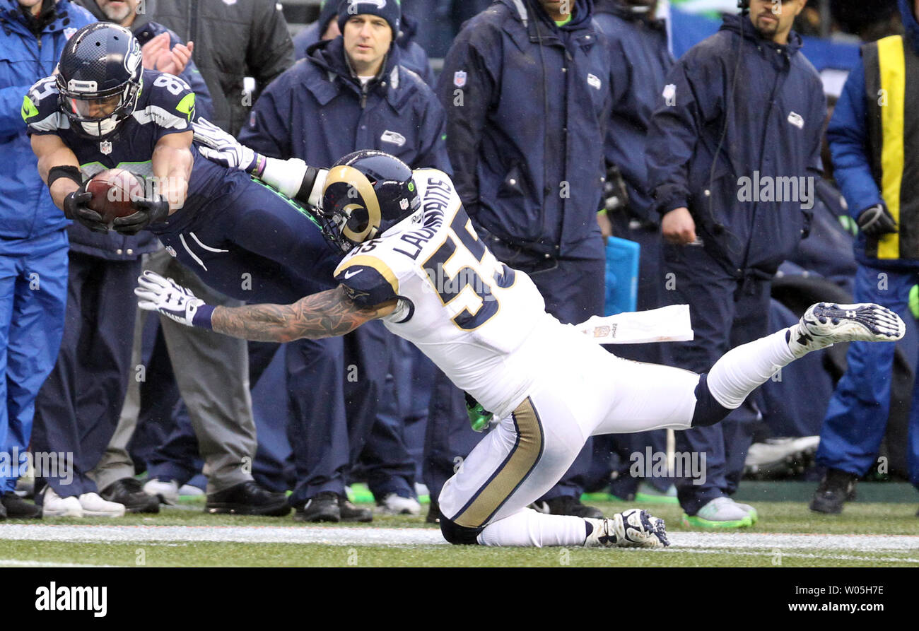 Seattle Seahawks wide receiver Doug Baldwin (89) lunges für eine erste, während durch St. Louis Rams Linebacker James Laurinaitis (55) an: CenturyLink Feld in Seattle, Washington am 27. Dezember 2015 in Angriff genommen werden. Die Rams schlagen die Seahawks 23-17. Foto von Jim Bryant/UPI Stockfoto