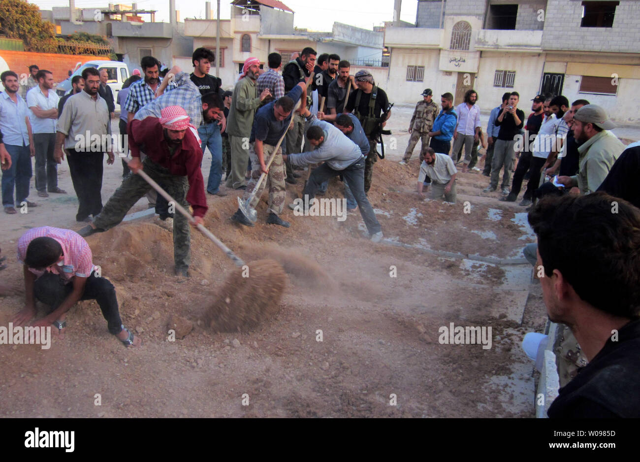 Bewohner, die Körper von Menschen, denen Aktivisten sagen, durch Truppen Syrien Präsident Bashar al-Assad, an Qusseer in der Nähe von Homs in Syrien, September 2, 2012 getötet wurden, den Streitkräften der Regierung eine Reihe von Bereichen, im Norden Syrien Teil der Bemühungen, die vom Regime rebel Festungen zu Zielen ohne Schale beerdigen. Truppen verwendet Ebenen mehrere Wohnungen in Aleppo, der Syrischen Beobachtungsstelle für Menschenrechte zu schlagen. UPI Stockfoto