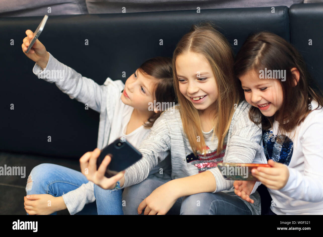 3 Mädchen mit Smartphone Stockfoto