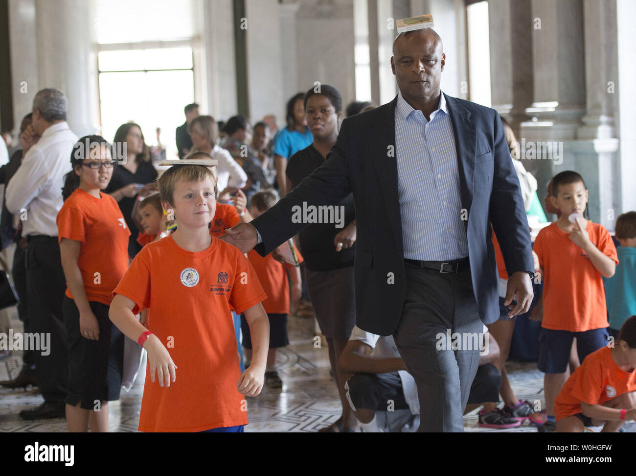 Pro Football Hall of Fame quarterback Warren Moon führt Kinder in eine Balance während einer Übung lesen wir die! Let's Move! Sommer lesen Veranstaltung an der Bibliothek des Kongresses am 30. Juli 2014 in Washington, D.C. Die Veranstaltung ist Teil der Abteilung der Bildung Initiative Jugend im Sommer lernen und körperliche Aktivität zu beschäftigen. UPI/Kevin Dietsch Stockfoto