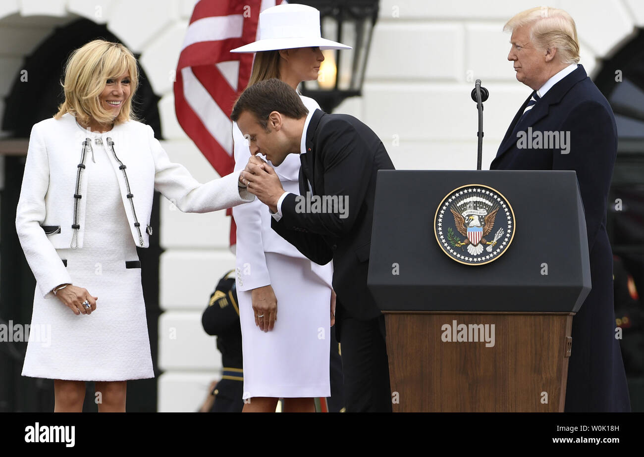 Der französische Präsident Emmanuel Längestrich küsse die Hand seiner Frau Brigitte als Präsident Donald Trump (R) und die erste Dame Melania Trump stehen am Ende der Staatsbesuch Begrüßung, im Weißen Haus, April 24, 2018, in Washington, DC. Die Staats- und Regierungschefs erwartet werden, den Handel, den Iran, den Klimawandel zu diskutieren, Nordkorea, Russland unter anderem. Foto von Mike Theiler/UPI Stockfoto