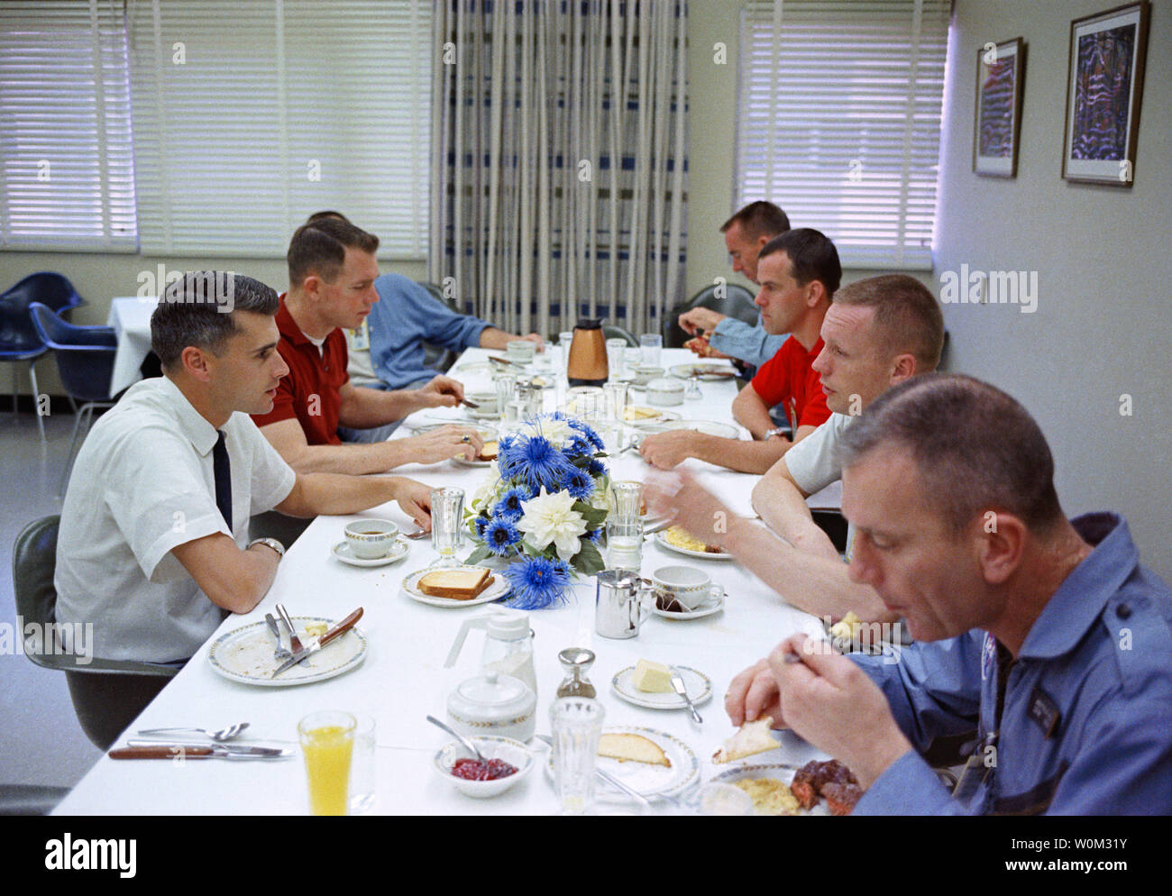 Der Gemini 8 prime Crew, zusammen mit einigen anderen Astronauten, haben ein herzhaftes Frühstück mit Steak und Eier am 16. März 1966, der Morgen der Gemini 8 starten. Sitzt im Uhrzeigersinn um den Tisch, beginnend an der unteren rechten, Deke Slayton, Bemannte Raumfahrt Center (MSC) stellvertretender Direktor für Flight Crew Operations; Astronaut Neil Armstrong, Gemini 8 Befehl Pilot; Wissenschaftler - Astronaut Curt Michel; astronaut Walter Cunningham; Astronauten Alan Shepard (Gesicht verdeckt), Chief, MSC Astronaut Office; Astronauten David Scott, Gemini 8 Pilot, und der Astronaut Roger Chaffee. März 16, 2016 kennzeichnet das 50th Anni Stockfoto