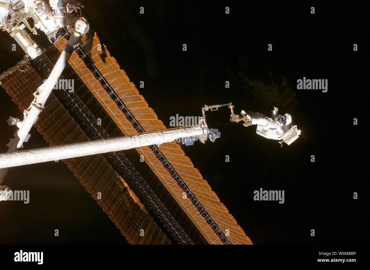 Während sie mit einem Fuß Zurückhaltung verankert am Ende des Orbiter Boom Sensor System (OBSS), Astronaut Scott Parazynski, STS-120 Mission Specialist, bewertet seine Reparatur arbeiten wie der solar array vollständig während der vierten Sitzung der Mission für Extra Vehicular Activity (EVA) während der Space Shuttle Discovery ist mit der Internationalen Raumstation am 3. November 2007 angedockt bereitgestellt wird. Während der 7-Stunden-, 19-minütigen Spacewalk, Parazynski eine Snagged Kabel installiert und hausgemachte Stabilisatoren entwickelt, um die beschädigte Struktur und Stabilität von solar array in der Nähe der Schäden zu stärken. Astronaut Doug Whe Stockfoto