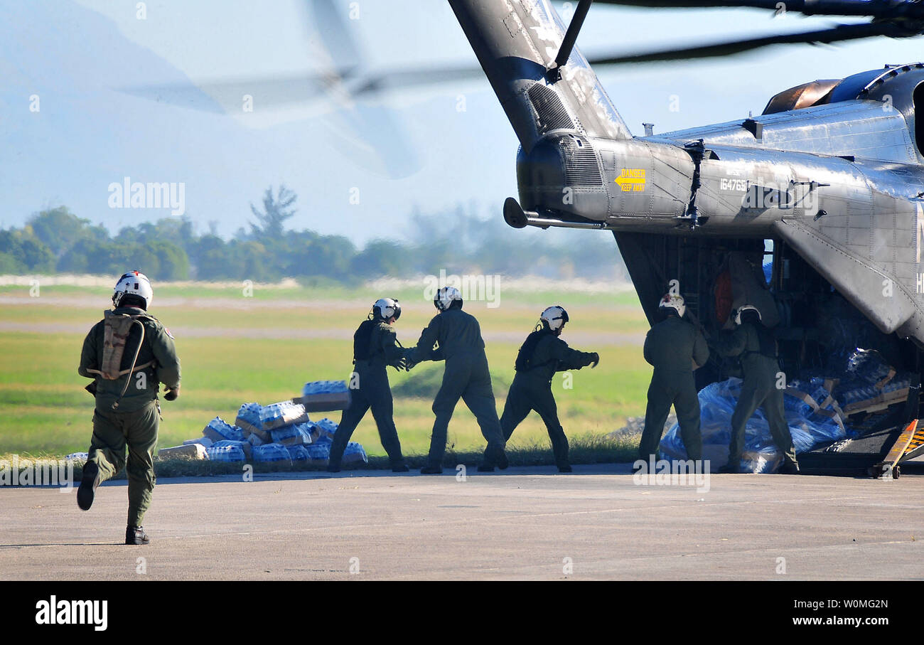 Us-Armee Soldaten Lebensmittel und Vorräte Entladen am 15. Januar 2010 von einem US-Marine MH-53E Sea Dragon Helikopter aus dem Flugzeugträger USS Carl Vinson (CVN 70) auf dem Flughafen von Port-au-Prince, Haiti. Das US-Militär ist die Durchführung von humanitären und Katastrophenhilfe nach einem Erdbeben der Stärke 7.0 schwere Schäden in der Nähe von Port-au-Prince am 12. Januar verursacht. UPI/Candice B. Villarreal/U.S. Marine. Stockfoto